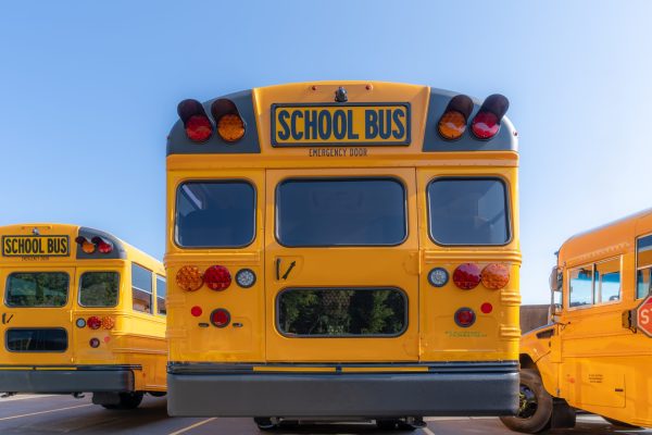 Rear,Of,A,Parked,Yellow,Electric,School,Bus,At,A